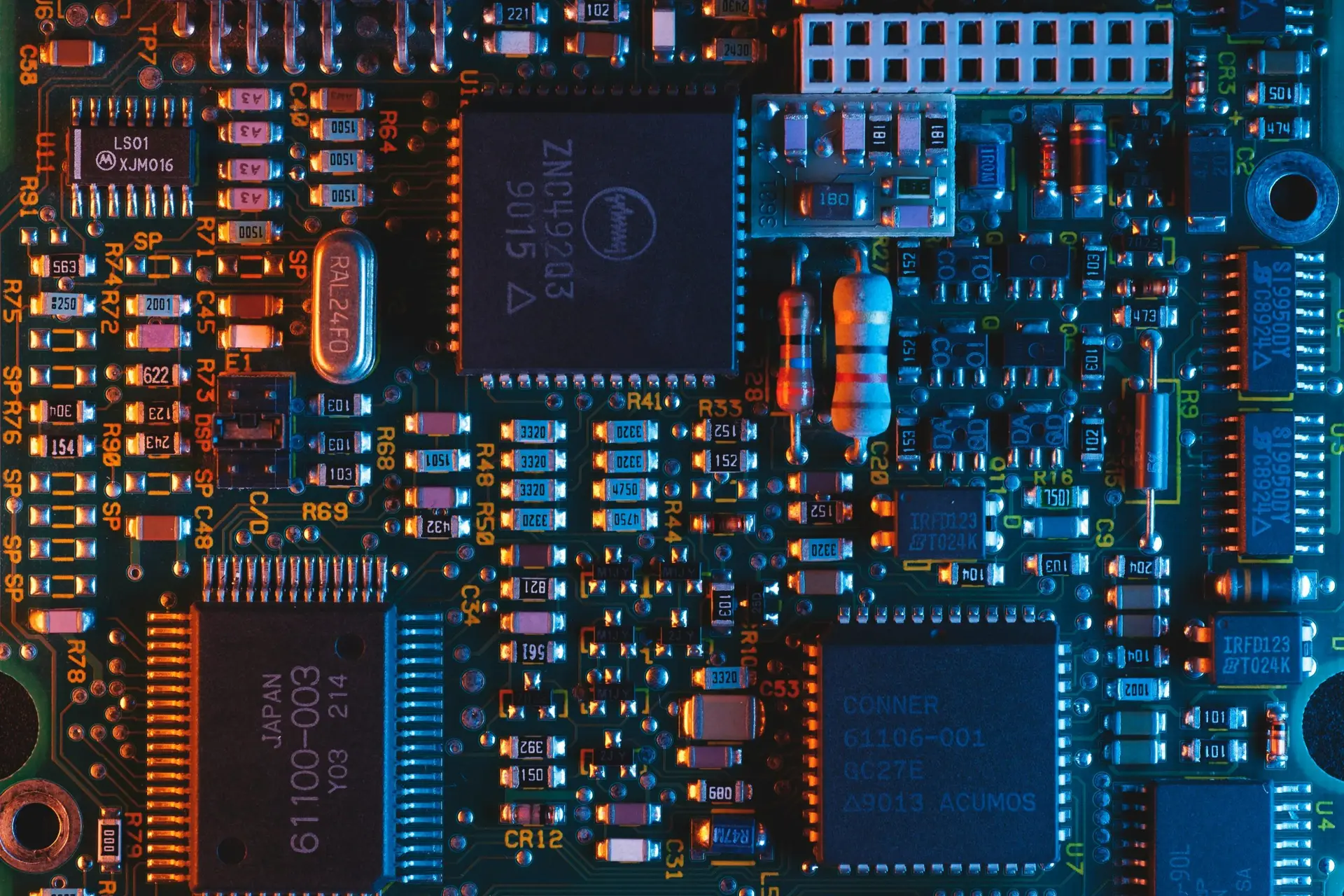 Close-up of a computer circuit board, illustrating the layered components and dependencies that an AI Software Bill of Materials inventories.